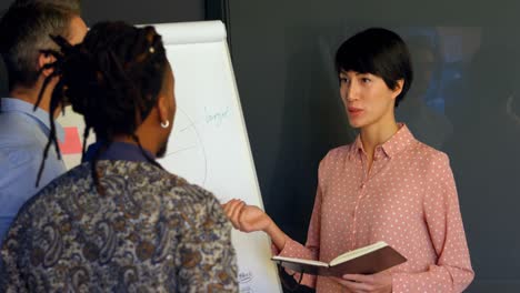 business executives discussing over whiteboard in conference room 4k