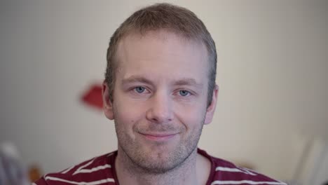 portrait of depressed man putting on a fake smile