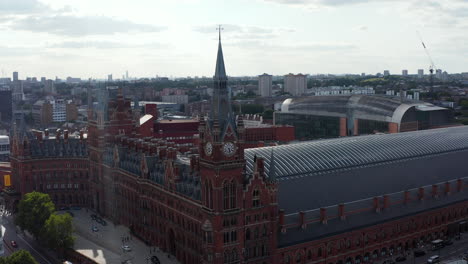 Slide-and-pan-shot-of-historic-brick-building-in-Victorian-style.-St-Pancras-train-station-in-Camden-borough.-London,-UK