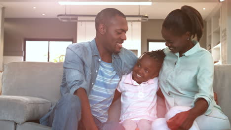 Parents-and-daughter-sitting-on-couch