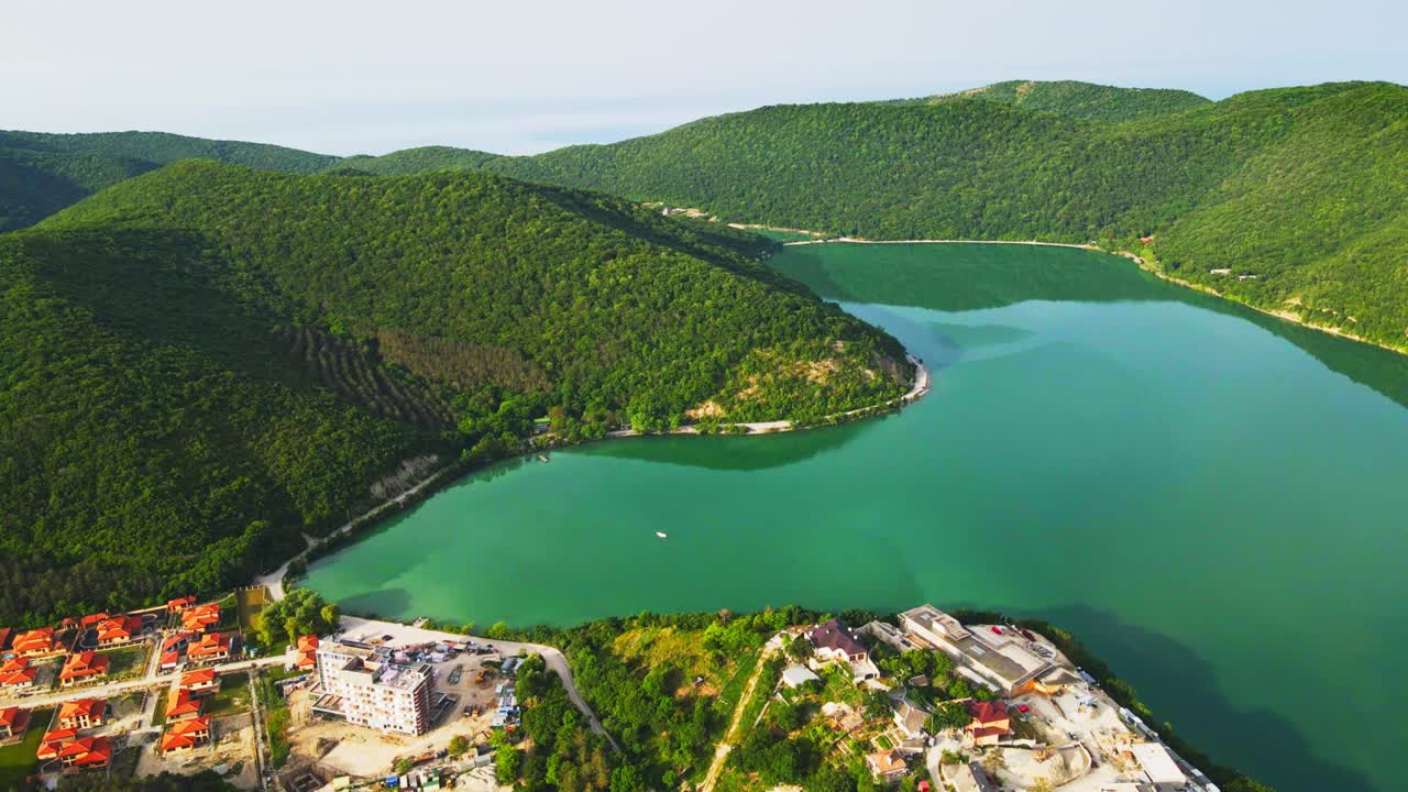 Lake with turquoise water in the green mountains with sea view.