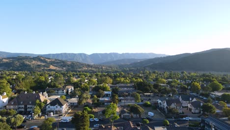 Solvang-Valley-Fly-Up-with-Majestic-Mountain-Backdrop,-Elevate-your-senses-with-this-soaring-aerial-fly-up-shot,-capturing-the-picturesque-Solvang-Valley-and-its-stunning-mountainous-backdrop