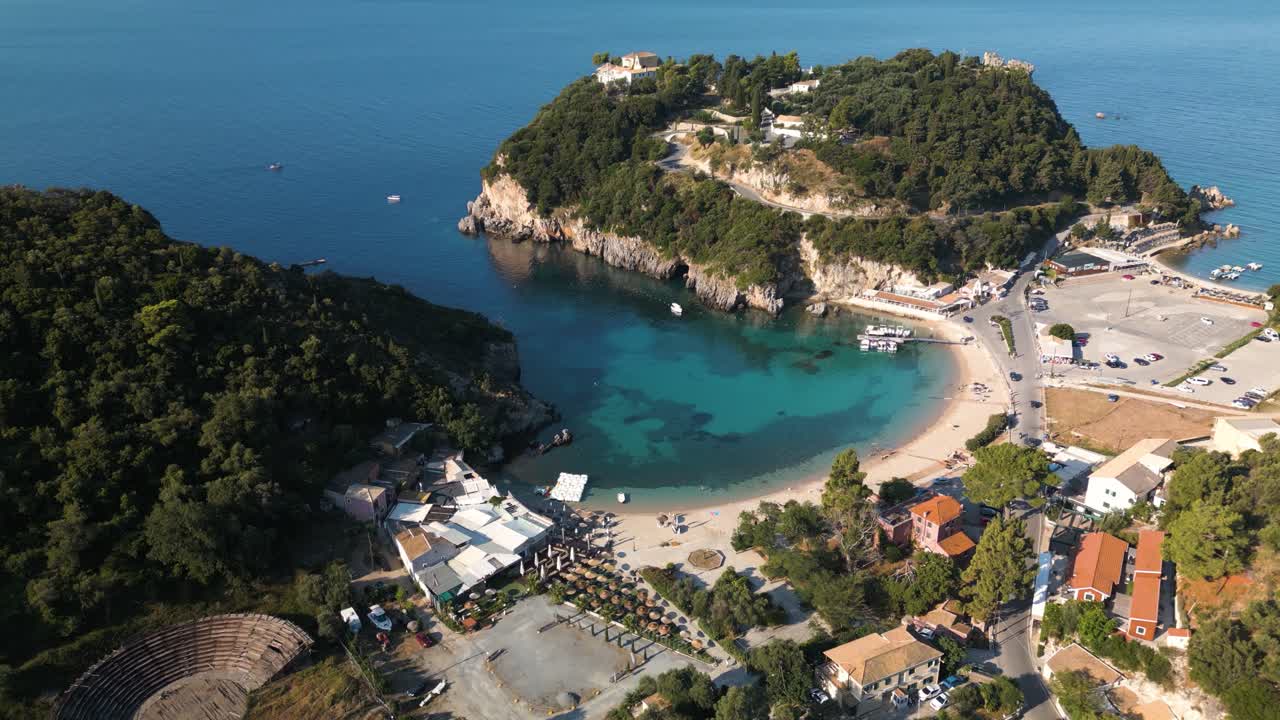 High angle aerial overview establishes stunning secluded sandy bay beach in Corfu Greece