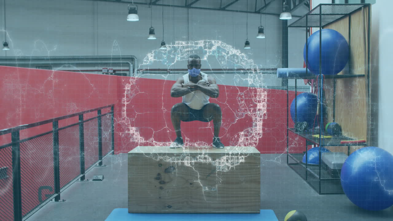 cervello umano che gira contro uomo afroamericano che indossa una maschera che salta su una scatola di plyo in palestra