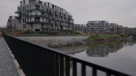 Moody-walking-shot-of-apartments-in-a-new-marina-bay-Prague