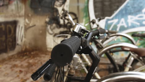 a close-up of a black bicycle's handlebars, with the grips, brakes, and frame all in sharp focus