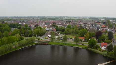 aerial approach to the shore of de kleine kreek small pond in the city of axel in the netherlands