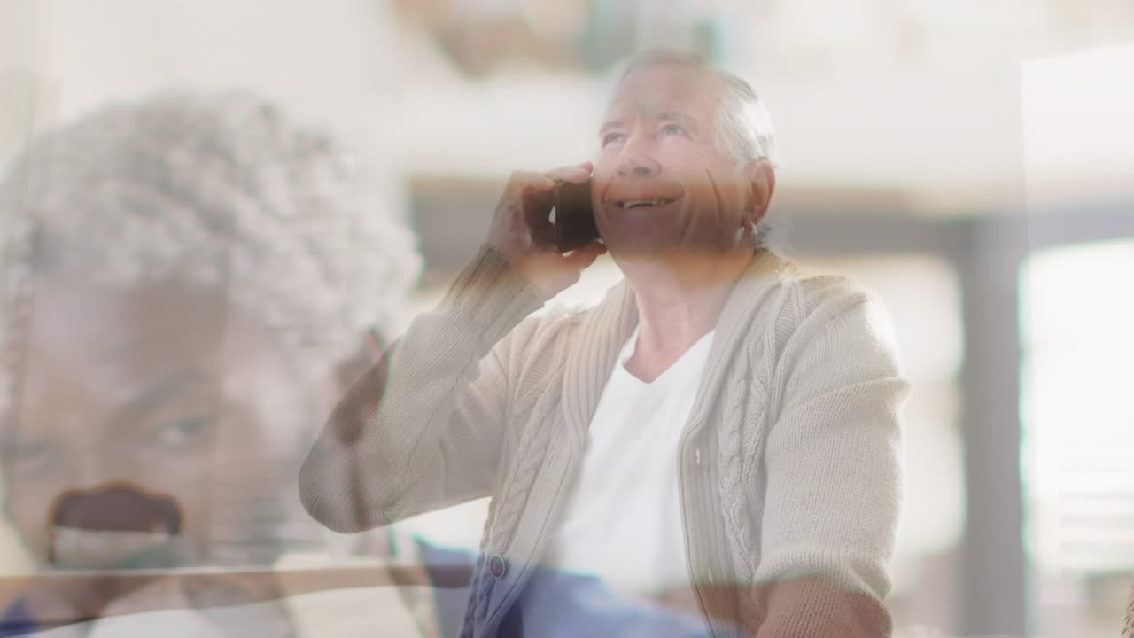 Animation of senior african american man over senior caucasian man talking on smartphone