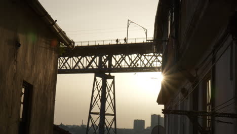 silhouette of people and dom luis i bridge in porto, view from bellow