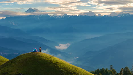 aerial view of heavenly hill landscape of shailung dolakha nepal under clear blue sky morning and mountains rise with the couple witnessing the nature's beauty while drinking tea and camping