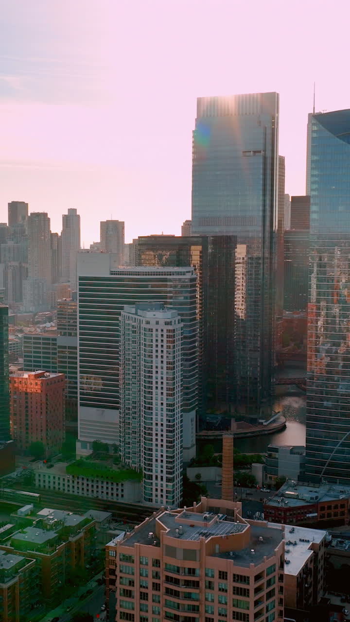 Morning establisher aerial of Chicago downtown, Illinois, USA. Aerial view modern skyline. Tall modern office buildings with glass facades. Vertical video