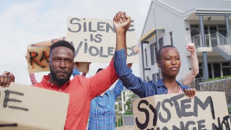 diverse group of protesters holding cardboard banners and screaming