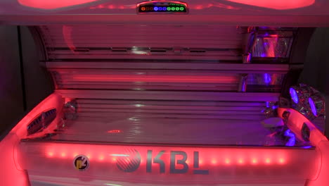 tanning sunbed lid open with led lights changing from pink to red