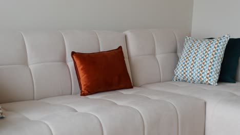 white sectional couch with colorful pillows