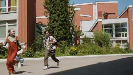 Group of Happy School Children Running Outdoors