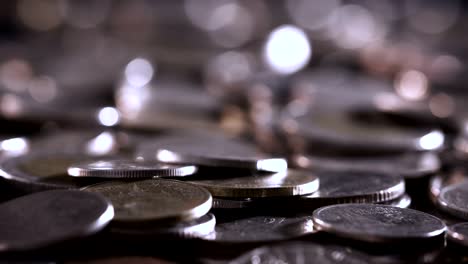 cerca de la moneda apilando monedas en el suelo en la luz oscura, negocios y financieros para ahorrar dinero o inversión concepto de fondo, extremadamente cerca y poco profundo dof