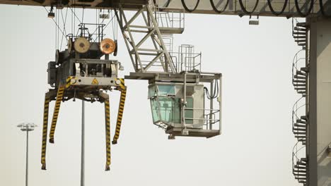 container crane cabin at a commercial dock during daylight, clear sky