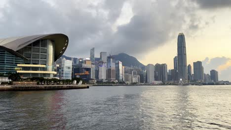 overcast sunset skyline of hong kong with convention center view from star ferry on victoria harbour