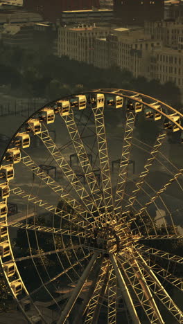 ferris wheel in a city at sunset