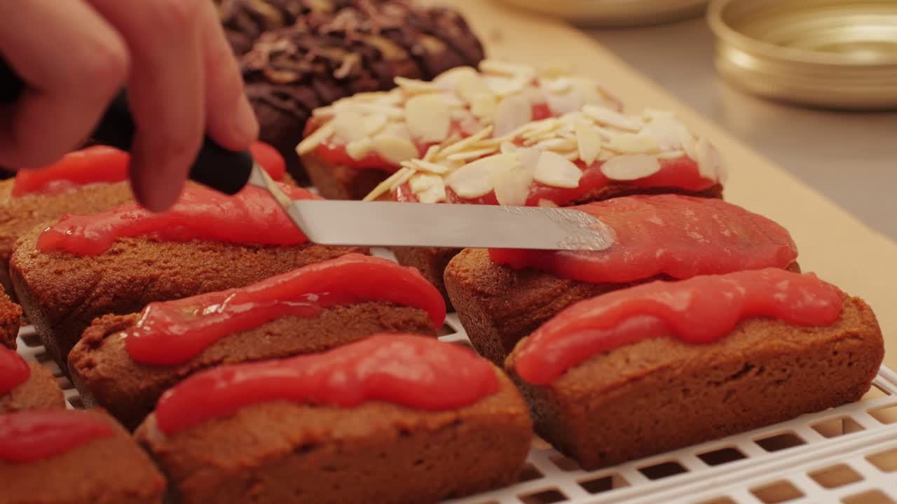 Artezan bread with red strawberry jam on top, fresh bake double chocolate banana artesian bread in bakery shop close-up. Artisan bread is making by skill bakers using natural and high-quality ingredients. Food with health and flavour benefits. Sweet breads for dessert and breakfast