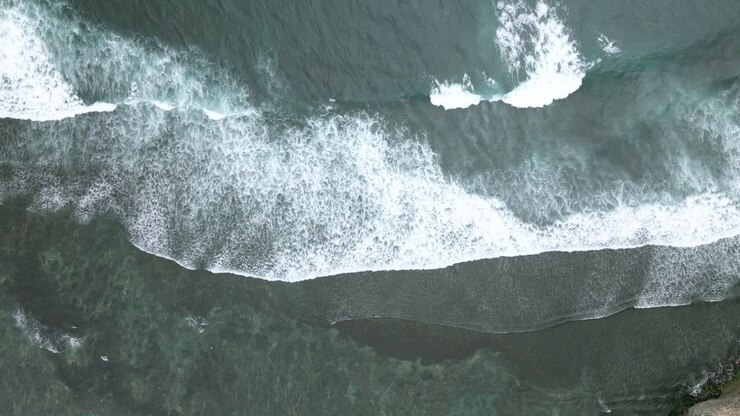 Drone fly over sea waves on the beach