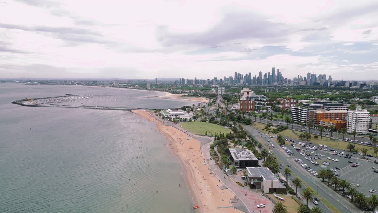 Aerial footage of St Kilda Beach with the Melbourne City Skyline in the background.