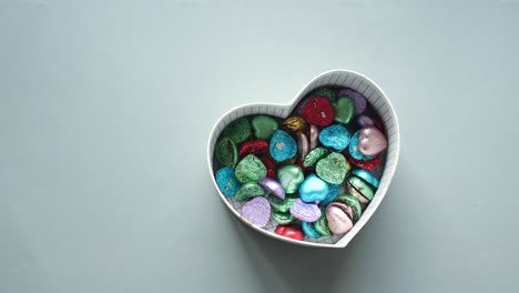 heart-shaped box filled with colorful chocolates