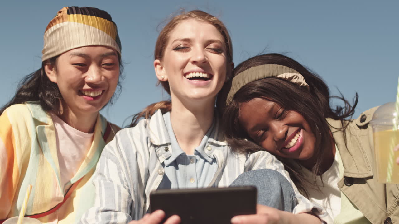 Multiethnic Girlfriends Laughing Outdoors in Summer
