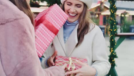 handheld view of friends exchanging their christmas presents