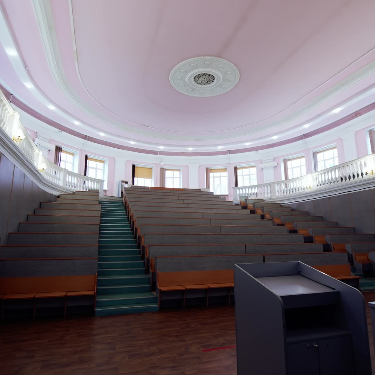 Modern auditorium for lectures. Empty conference hall at the university. Meeting room for educational purpose. Motion camera back to the door