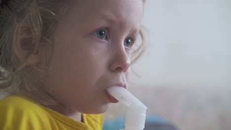 tired girl undergoes medical procedure with inhaler in room