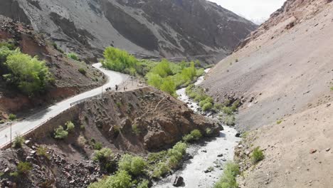 road and river crossing thought the dry mountains in ladakh, india