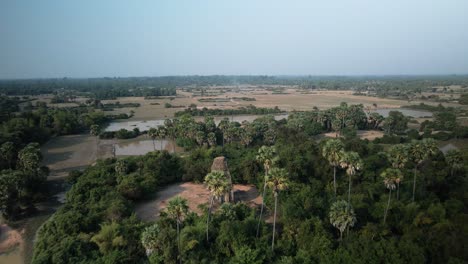 forgotten temples cambodia - trapeang pong tower drone fly over birds eye view in dry countryside