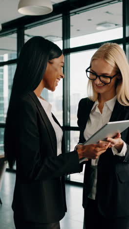 professional businesswomen collaborating and interacting happily in a modern office