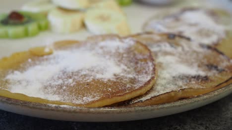 closeup of pancakes with powdered sugar