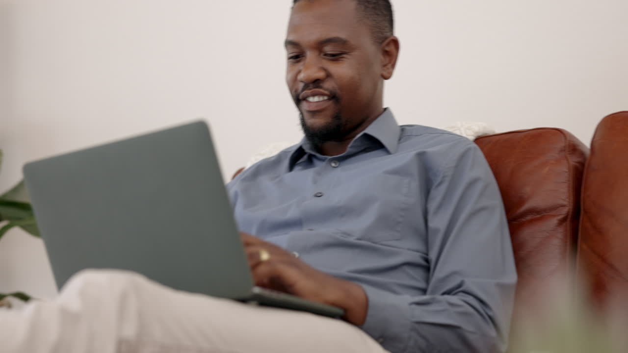 Laptop, typing and business man on sofa for work