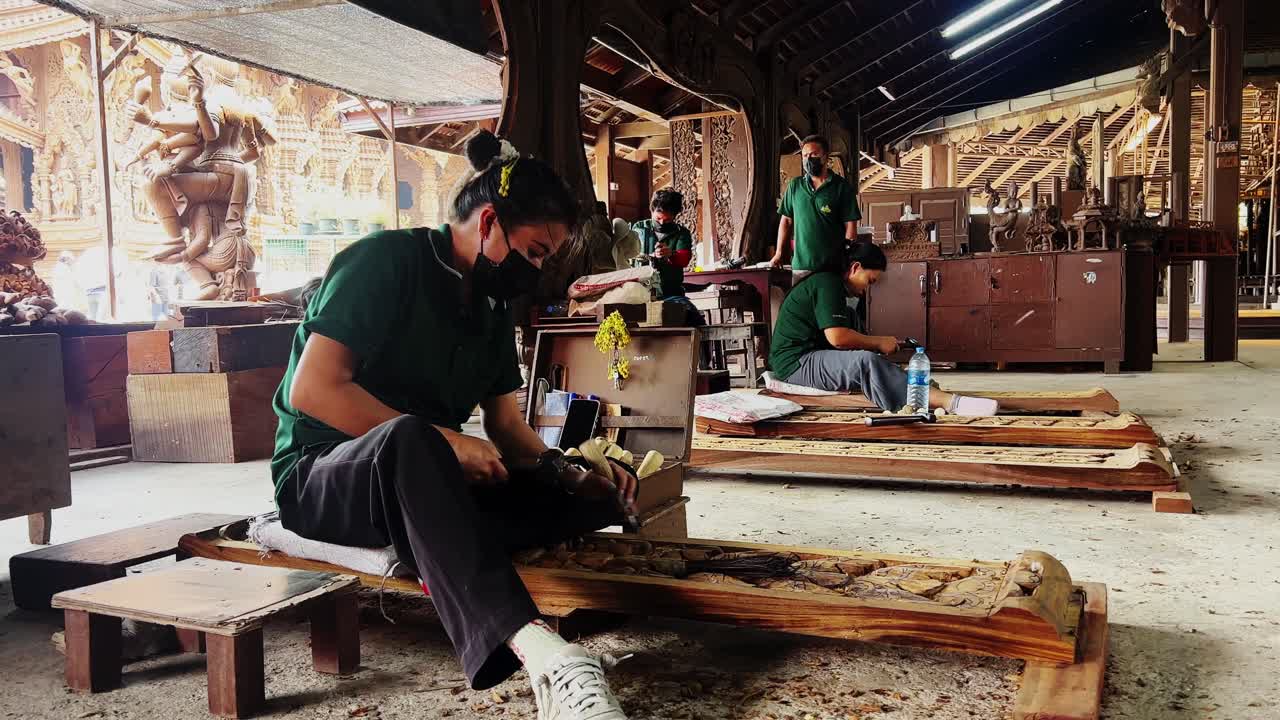 few girls are carving the wood pieces for a project
