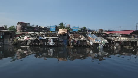 Aerial-of-Slum-Area-along-the-polluted-canal-in-Tondo-Manila,-Philippines