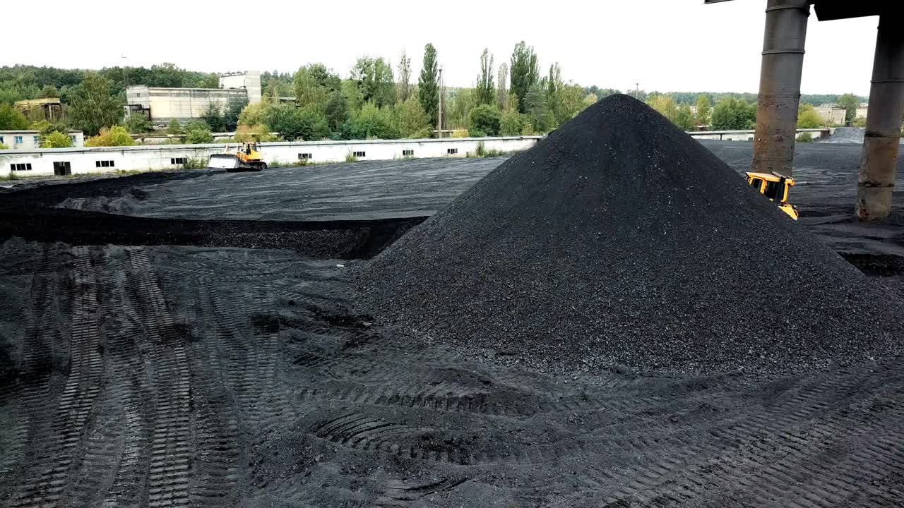 Aerial view of big pile of coal. Extractive industry, anthracite. Coal mining at an open pit