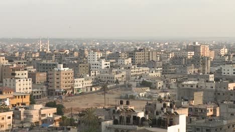 wide shot of gaza, densely populated area with spires from a mosque in the background