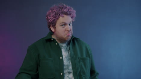 man with pink hair giving thumbs up