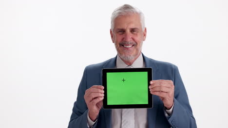 mature businessman holding a tablet with a green screen