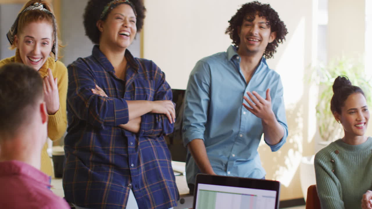 Happy diverse business people discussing work during meeting at office