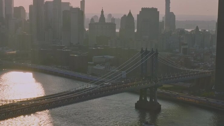 View of Manhattan from Brooklyn Bridge at sunset over East River
