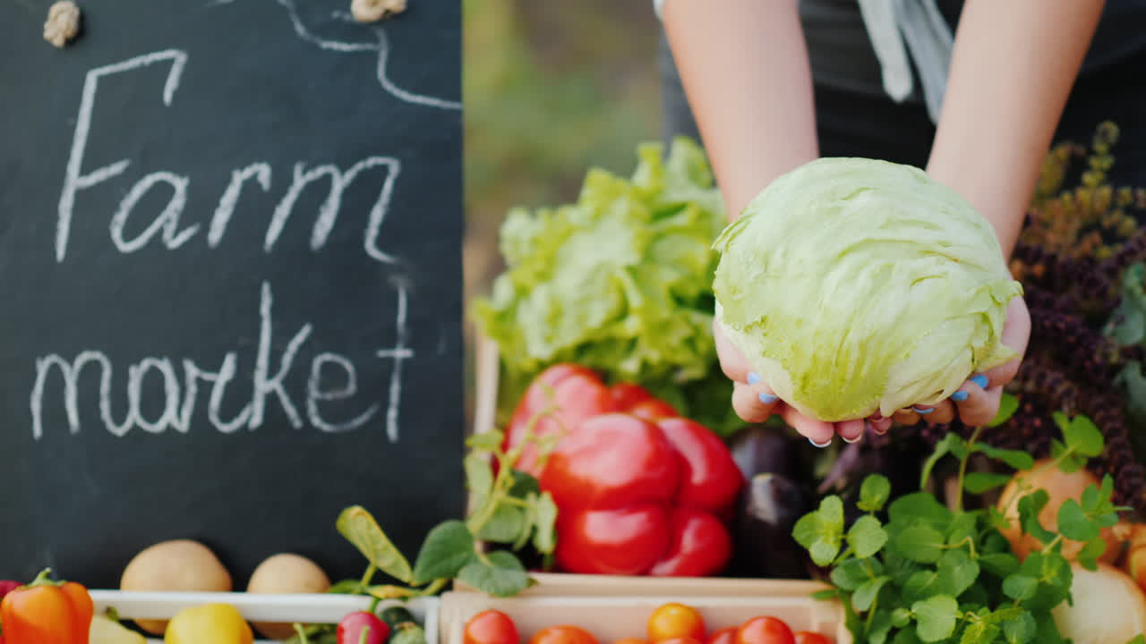 농부는 농업 박람회에서 카운터 위에 양배추 머리를 들고