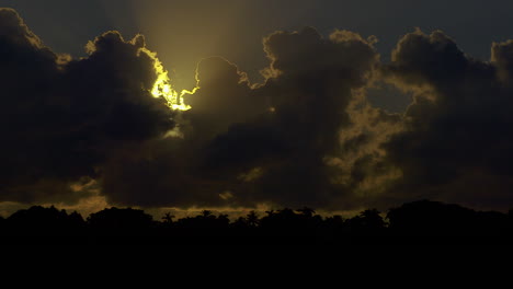 morning sun beginning to emerge from behind dark clouds in south florida, u