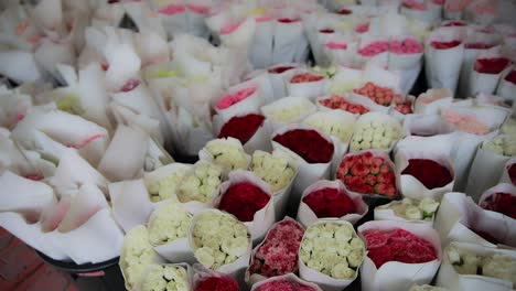 bouquet's of roses wrapped at a flower market in bangkok, thailand