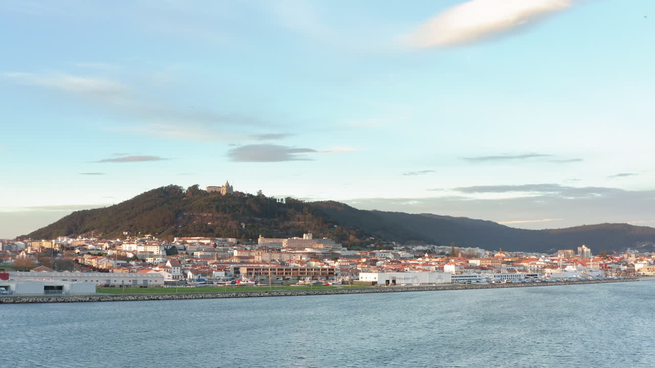 View to Viana do Castelo cityscape over the Lima river waterfront - Aerial wide slide tracking shot