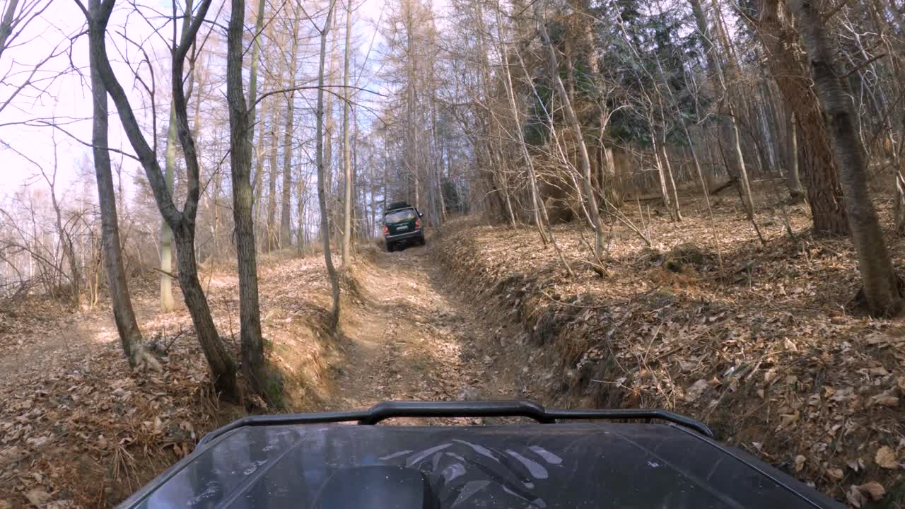 Off-road 4x4 vehicles driving on dirt forest road - GoPro 4k window pov