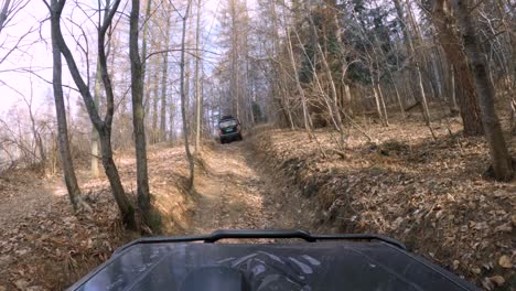 off-road 4x4 vehicles driving on dirt forest road - gopro 4k window pov